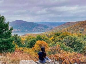 Woman sitting on overlook of Storm King State Park