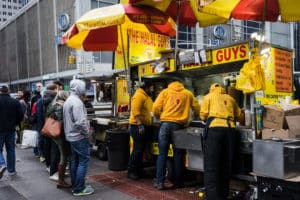 People at Halal Guys food cart in NYC