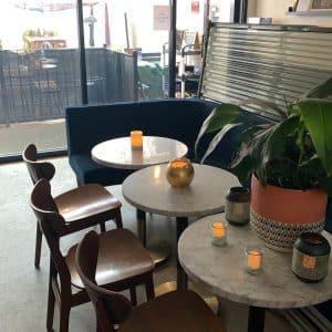 Tables with candles and chairs at Heart of Gold in Astoria, Queens