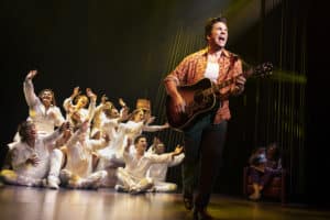 Will Swenson as ‘Neil Diamond – Then,’ Linda Powell as ‘Doctor’ (in background), and The Noise.