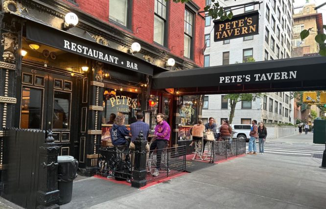 People having a drink outside of Pete's Tavern