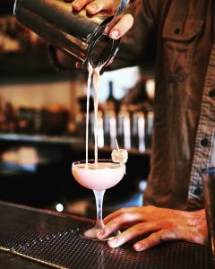Person pouring cocktail at Attaboy