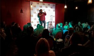Comedian on stage at LOL Comedy Lounge, one of the best comedy clubs nyc