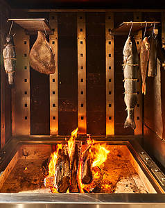 Fish being cooked over an open flame