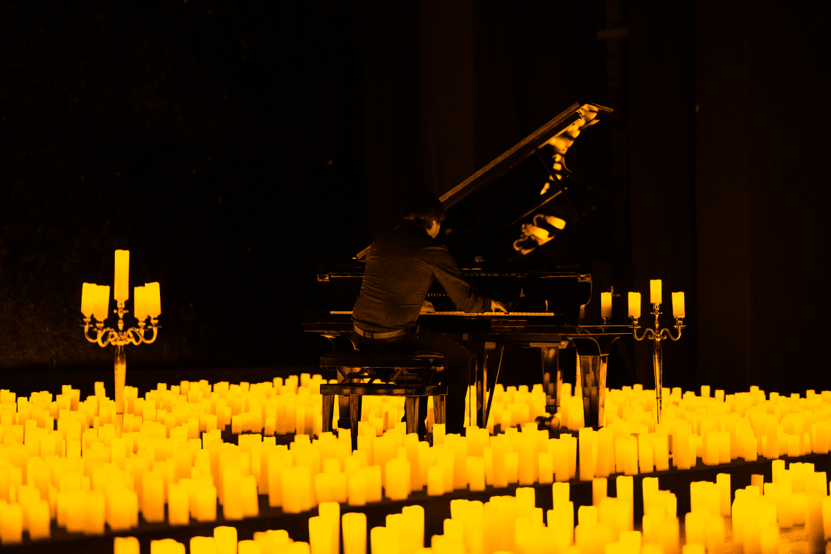 A pianist performing by candlelight
