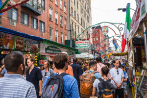 View of the Annual Feast of San Gennaro street festival on the street of Little Italy in Manhattan with food vendors, decorations and real people in view.